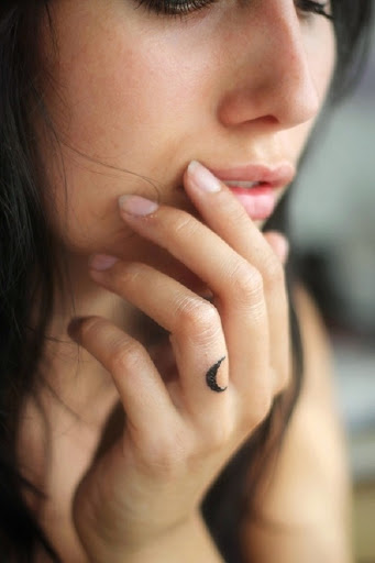 small moon tattoo half on finger girl